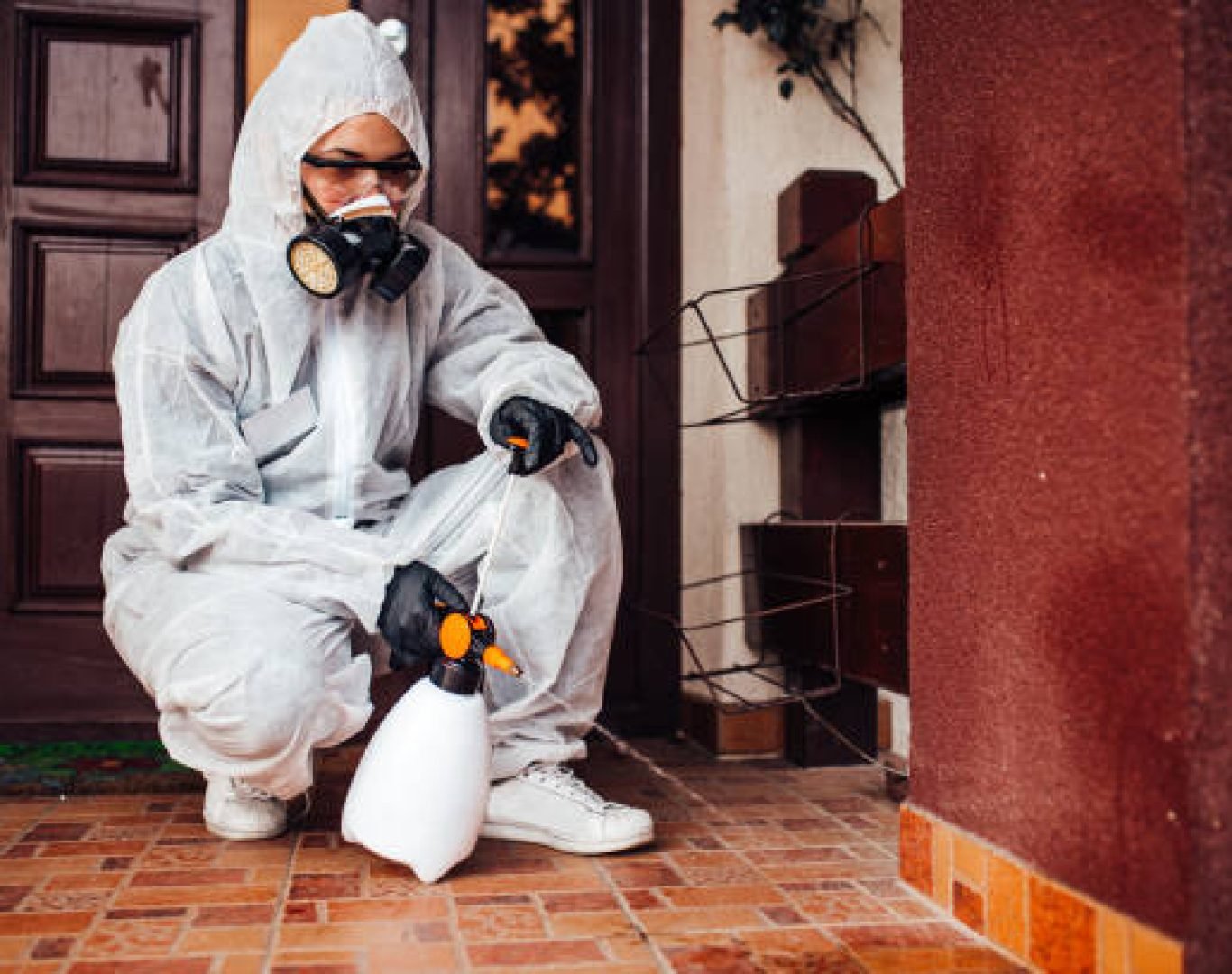 DeAnza Termite & Pest Control applying treatment around house perimeter